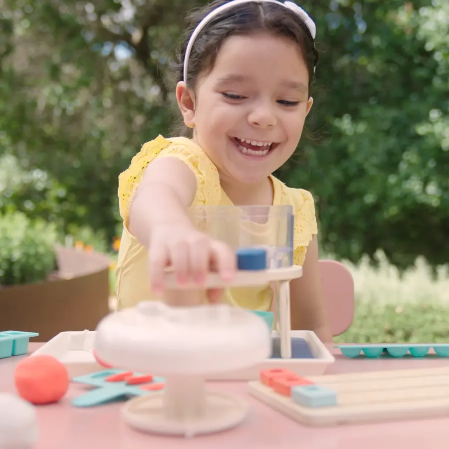 kid playing with pretend shaved ice maker