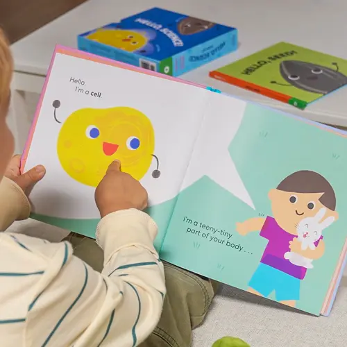 kid reading book pointing at book