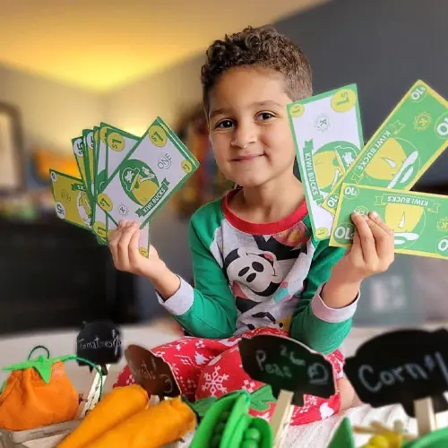 kid playing with pretend money