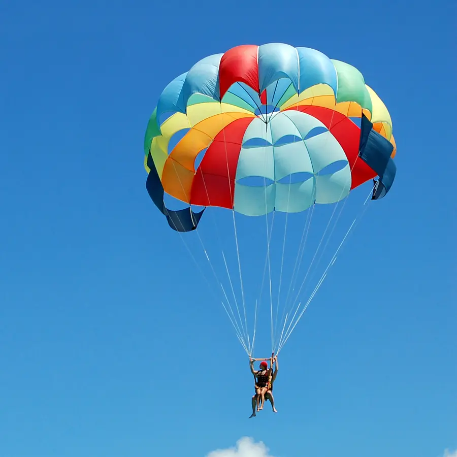 person parachuting down from sky